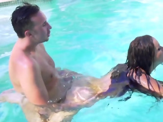 The brunette with big round tits is having some sexual fun and games with her horny boyfriend in a swimming pole. The combination of the summer sun an