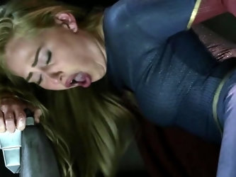 A blonde is in the Supergirl parody where her costume gets ripped apart and then she gets some anal sex done to her by the villain after she gives him